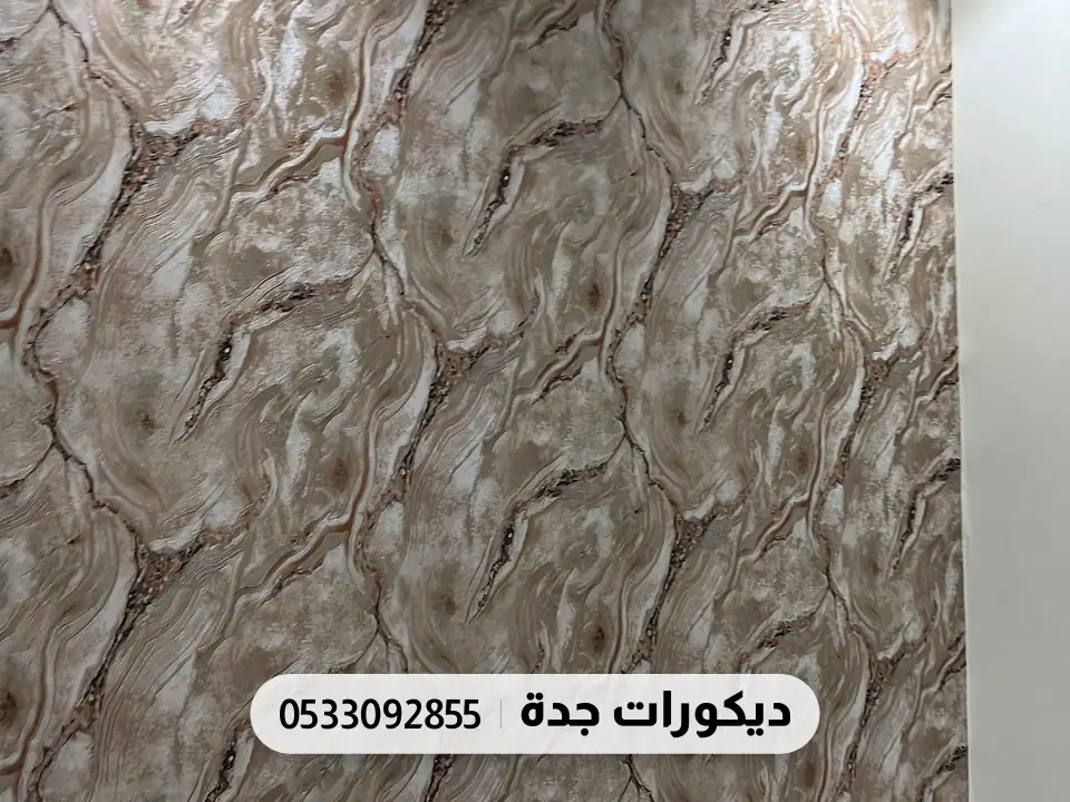 جدار بورق ملمسه رخامي مجعّد بدرجات البني والرمادي وإضاءة من الأعلى