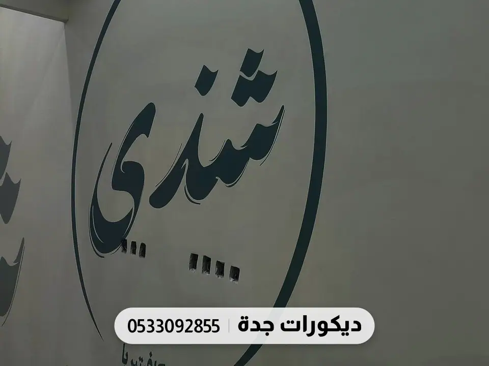 شعار محل شندي مطبوع بالأسود على جدار رمادي داكن